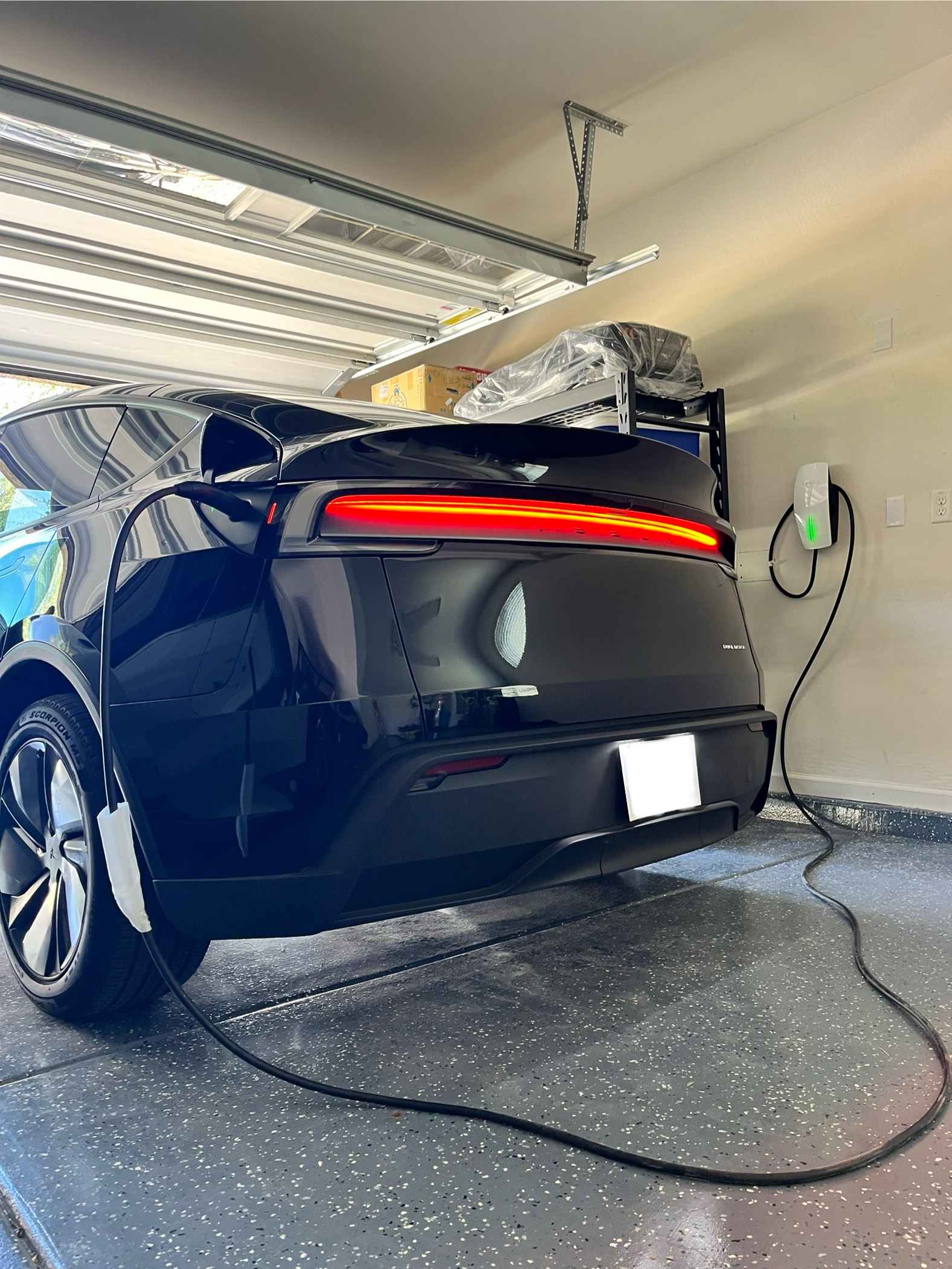 Tesla Model 3 charging in modern Phoenix garage with professional EV charger installation